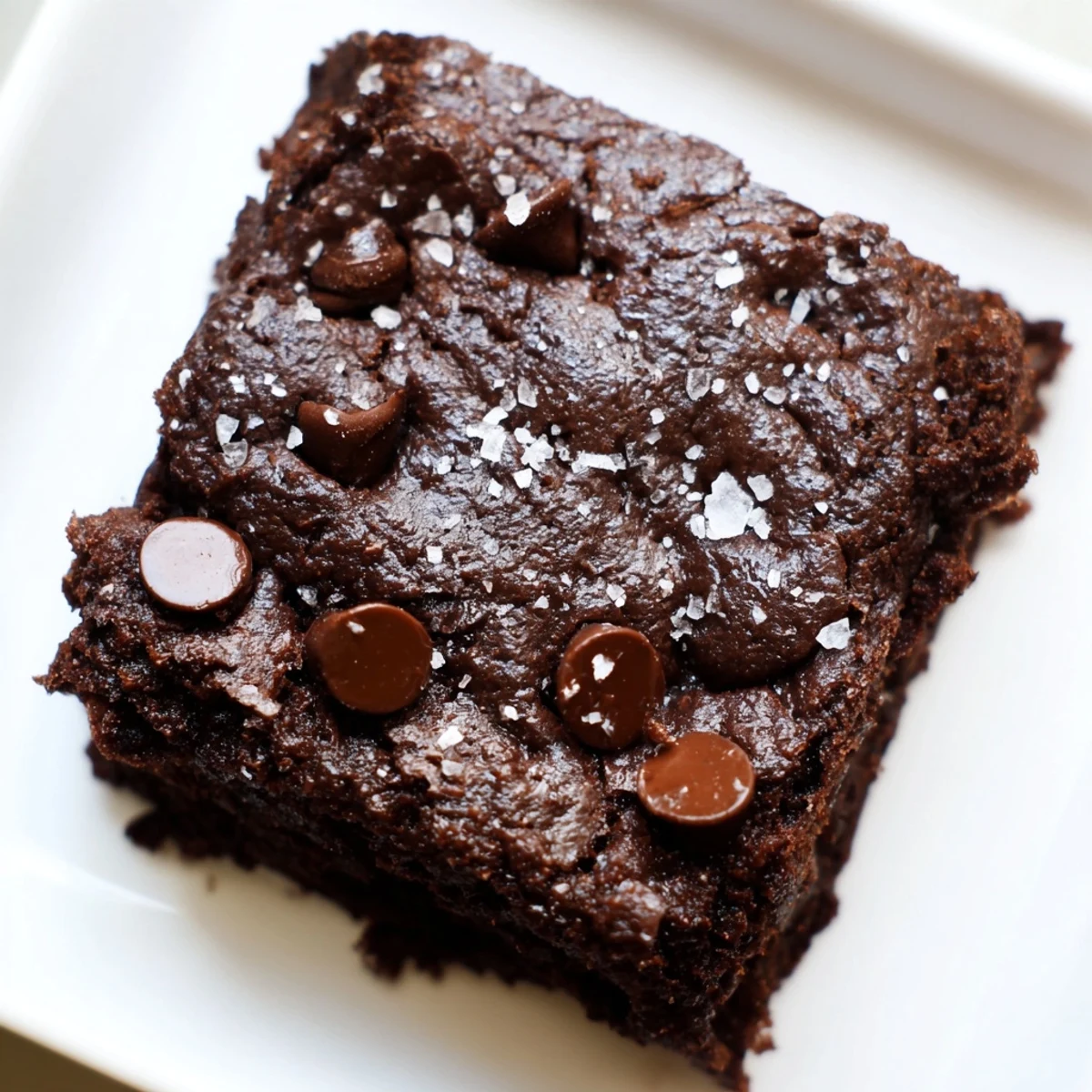 Gluten-Free Almond Flour Brownies with Sea Salt cooling on a wire rack, showcasing the crinkly top and flaky salt.