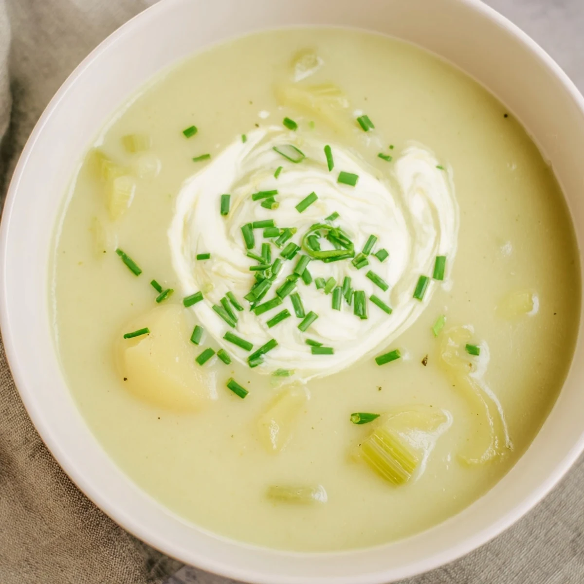 Smooth blended Irish Leek and Potato Soup topped with parsley, ready to enjoy with crusty bread.