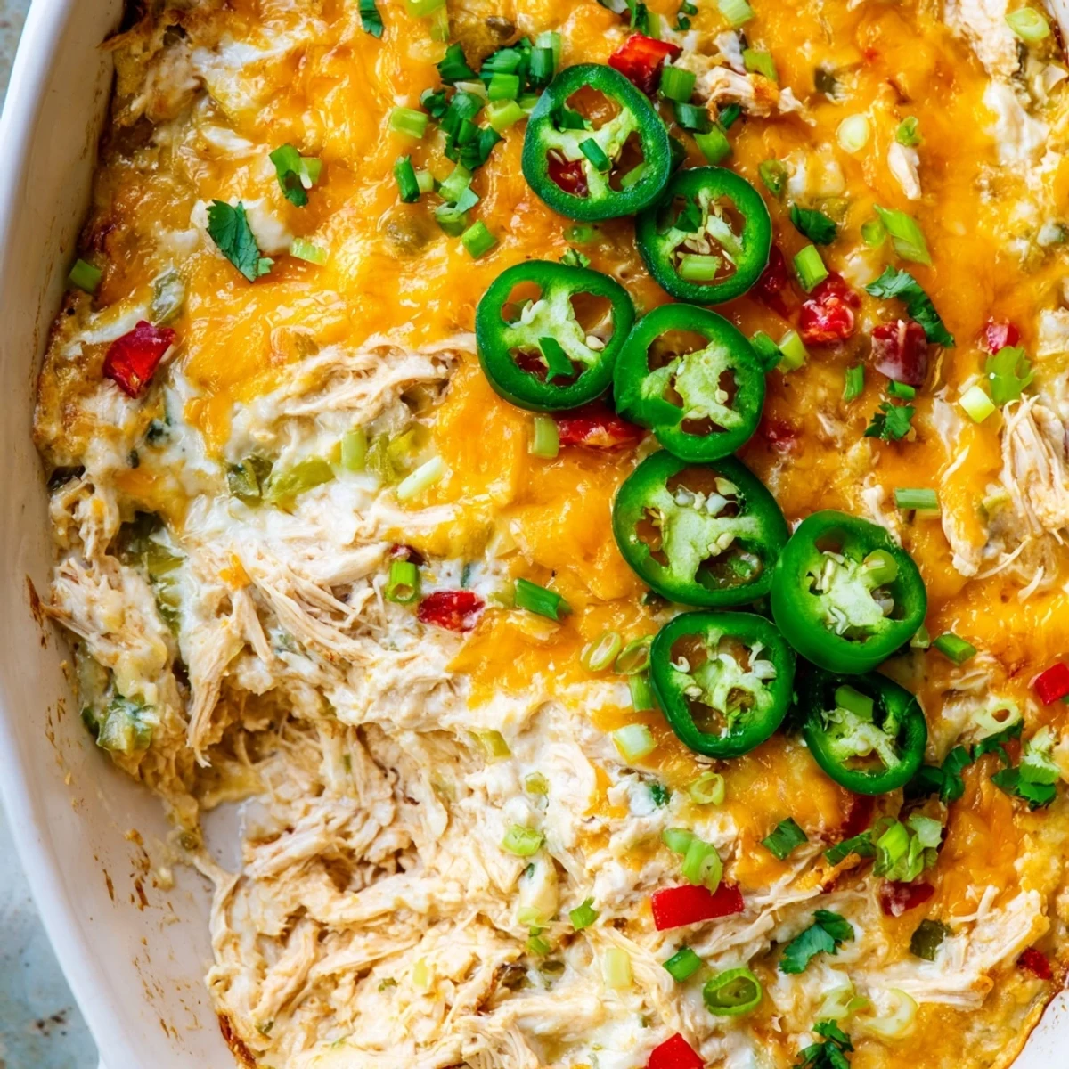 Warm and hearty Chicken Enchilada Dip in a rustic dish, ready for a game day appetizer spread.
