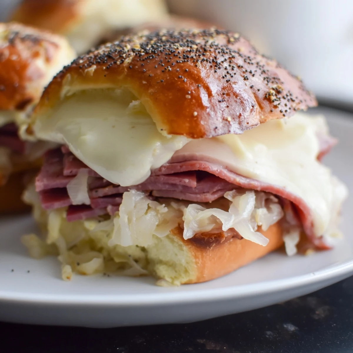 Stacked Corned Beef Sliders with Swiss cheese on a wooden board, showcasing tender meat and melty cheese for a party appetizer.