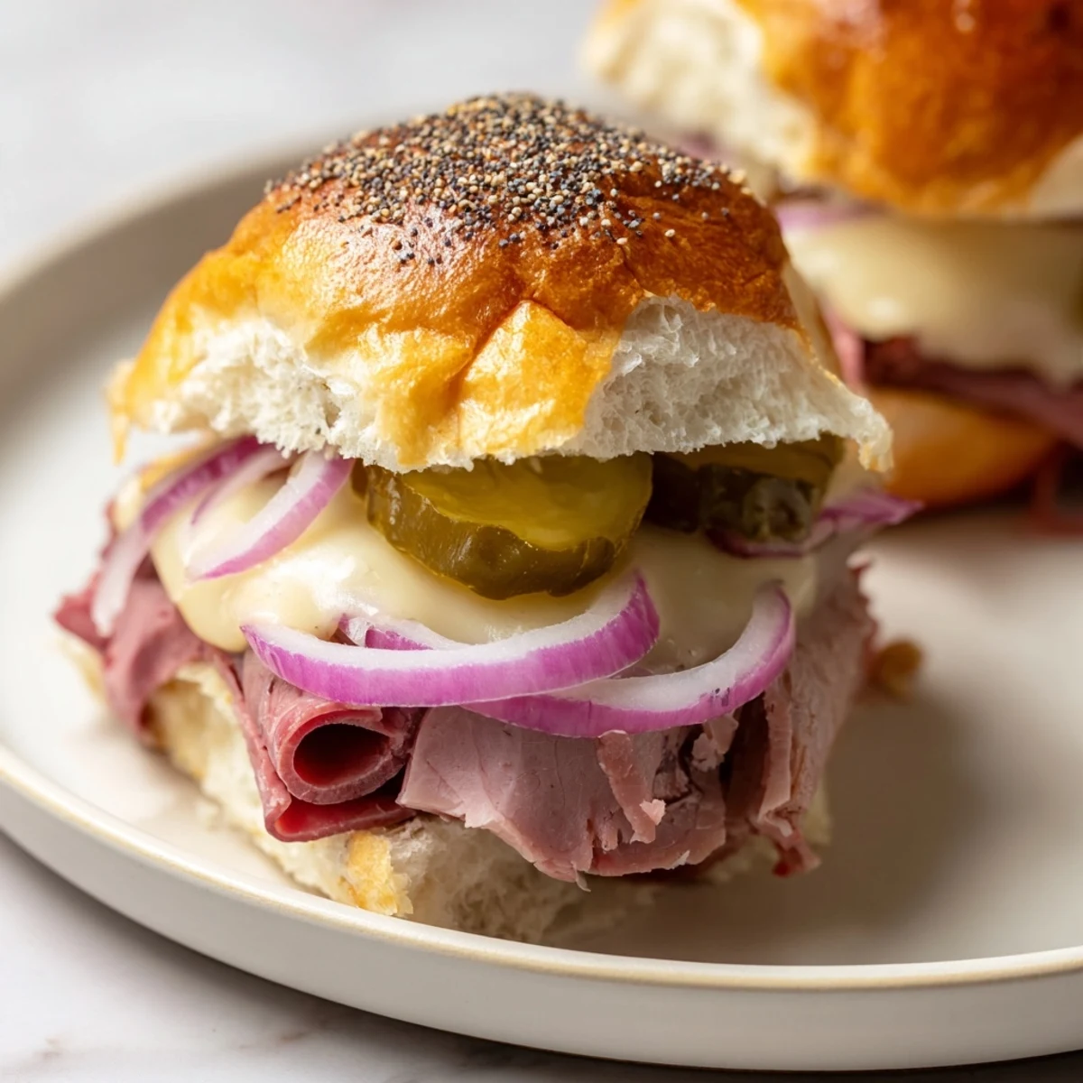 A close-up of Corned Beef Sliders with Swiss Cheese, garnished with fresh dill, served beside a bowl of tangy slaw.
