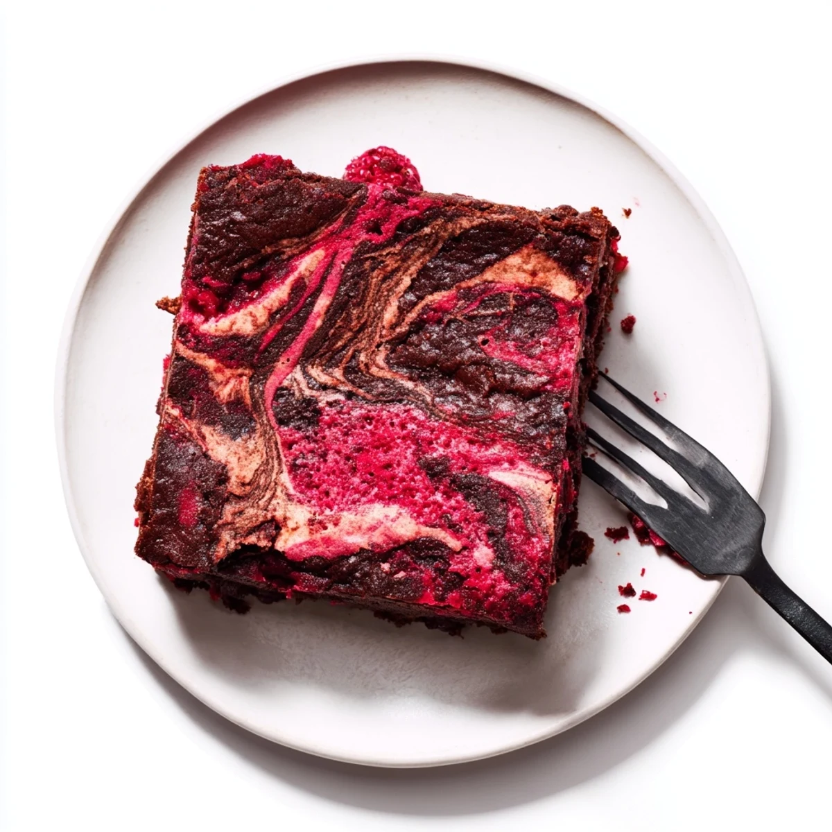 Warm Raspberry Swirl Brownies cut into squares, featuring a rich chocolate base and tangy berry ribbons, perfect with a scoop of vanilla ice cream.