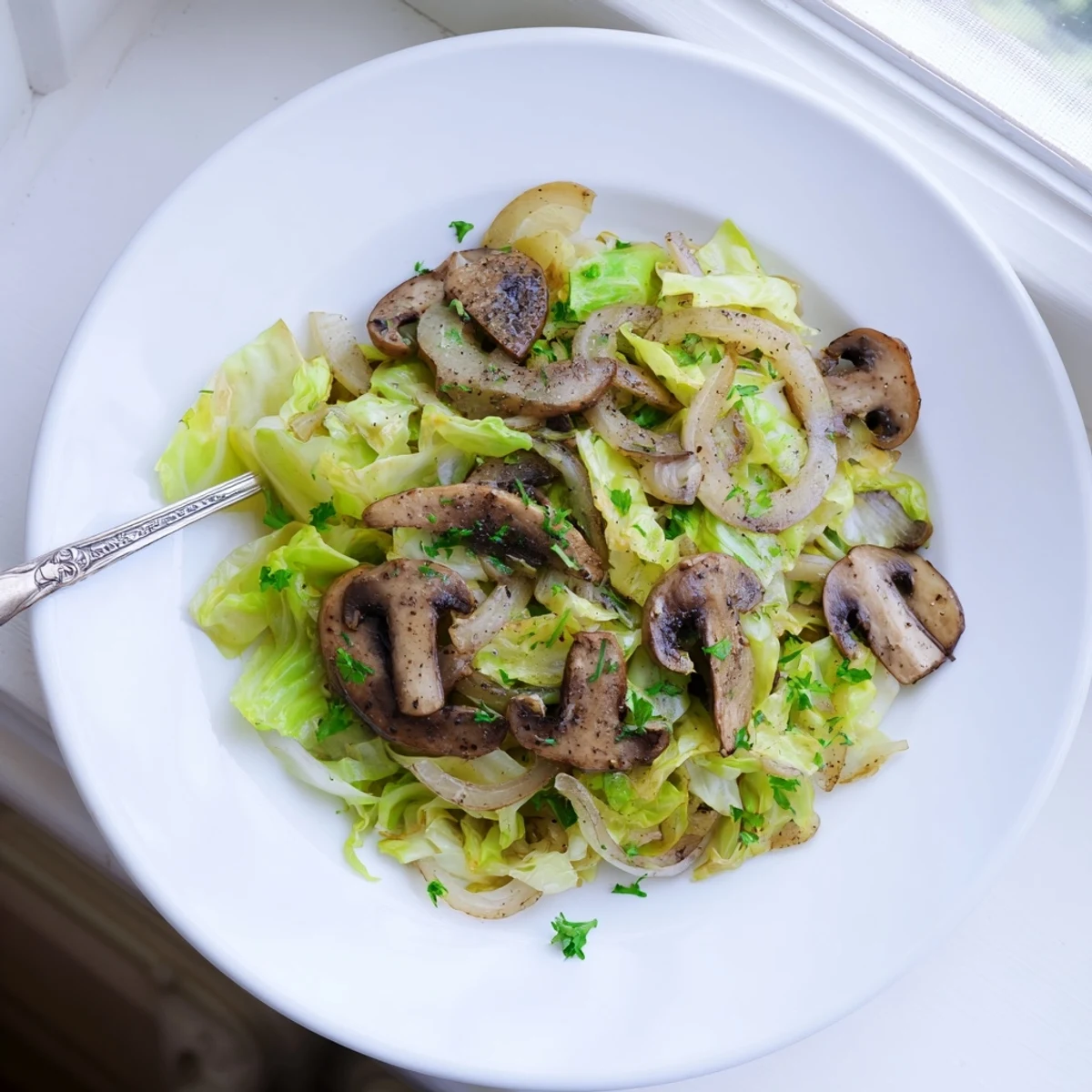 Brightly colored Vegetarian Cabbage Mushroom Sauté with sautéed cabbage and browned cremini mushrooms, garnished with fresh parsley.