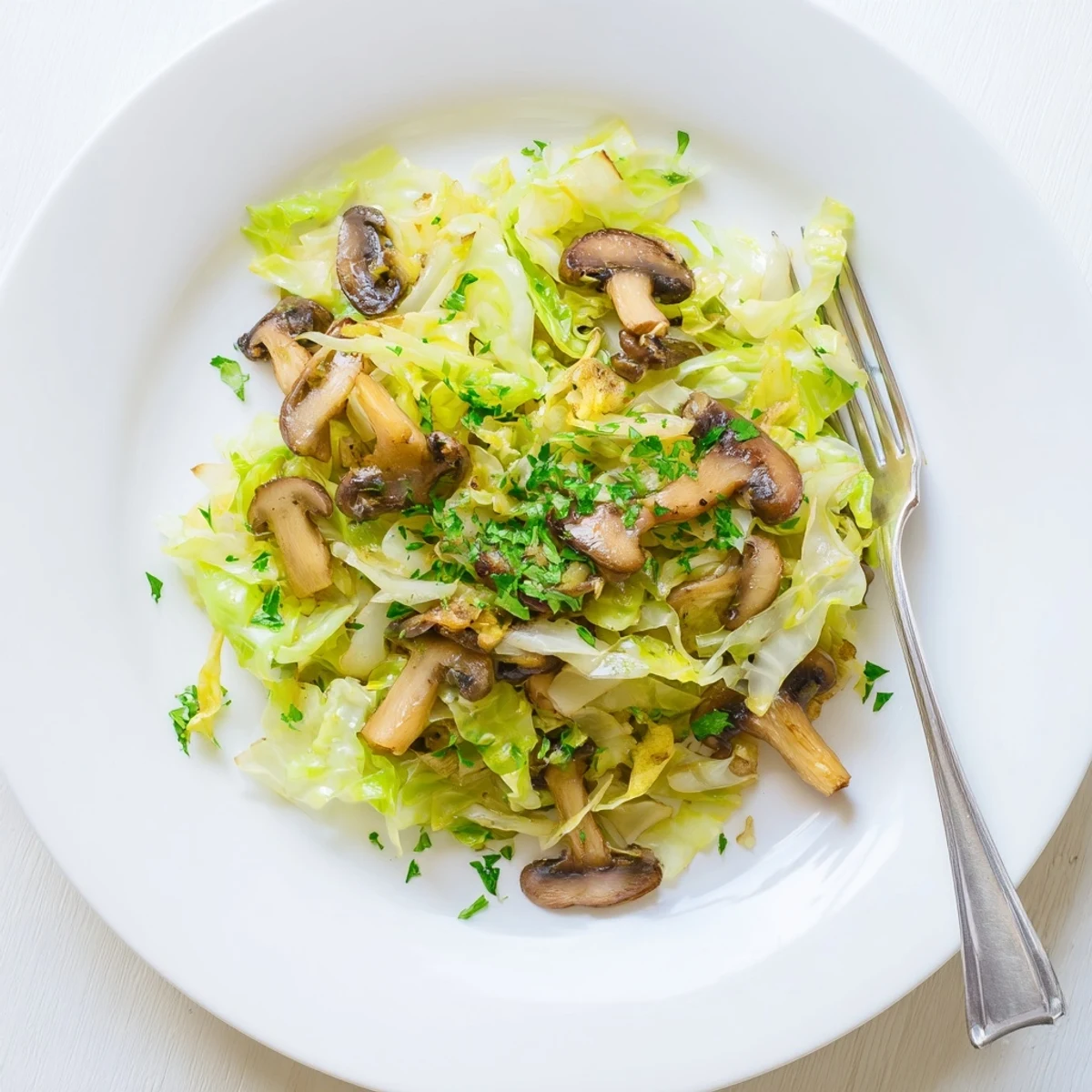 Plated Vegetarian Cabbage Mushroom Sauté served next to fluffy quinoa, highlighting a savory, herb-infused side dish for dinner.