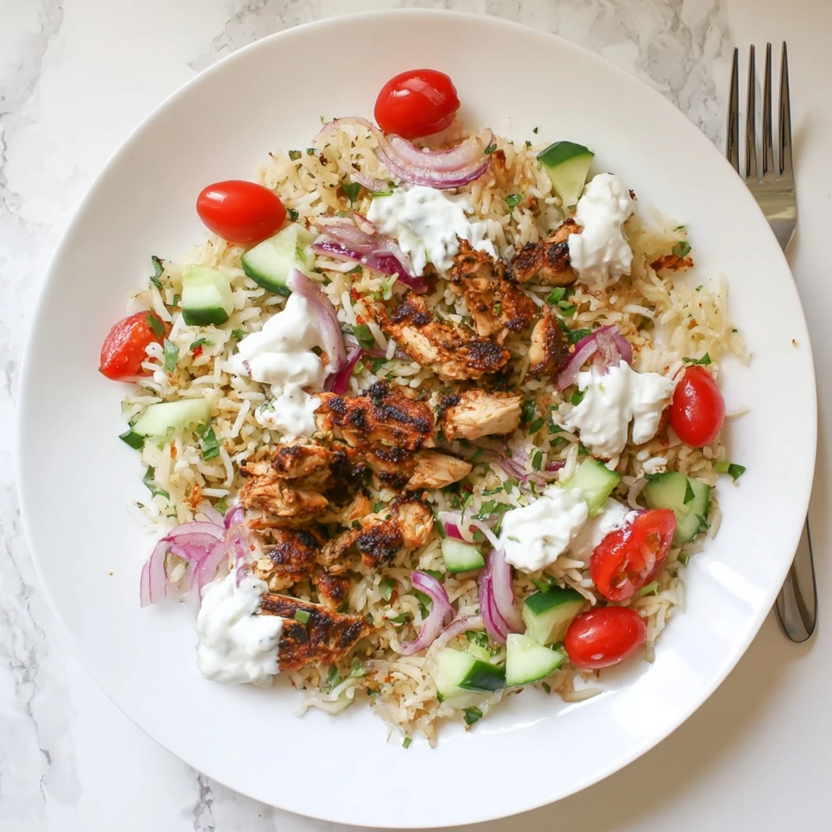 Colorful chicken shawarma crispy rice salad bowl with spiced chicken, fresh vegetables, and creamy yogurt topping
