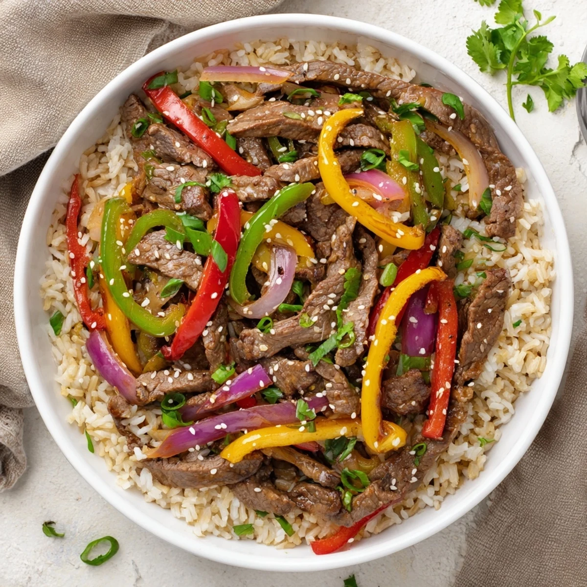 Vibrant Asian-inspired healthy beef and pepper rice bowl with crisp vegetables and savory glazed beef