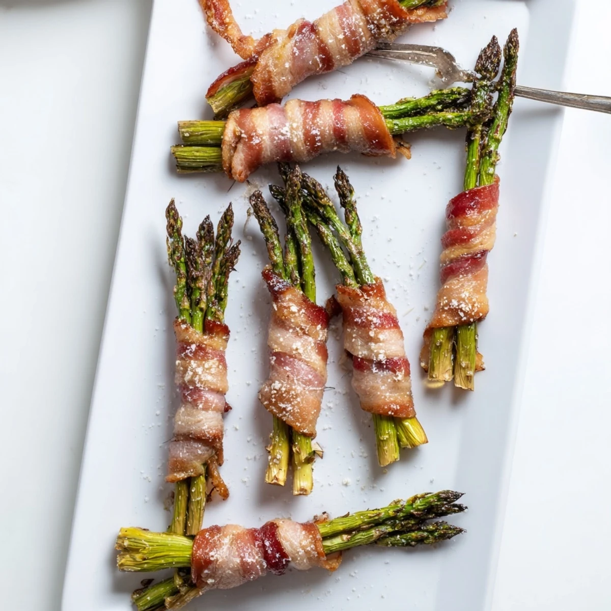 Tender green asparagus bundles wrapped in smoky bacon, baked to golden perfection