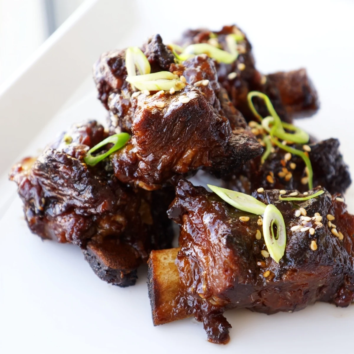 Tender Korean Galbi grilled ribs caramelized to perfection with charred edges and sesame garnish