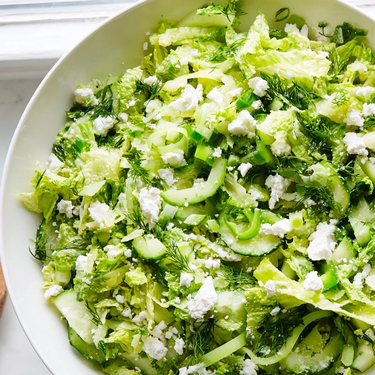 Fresh Maroulosalata Greek salad with crisp romaine, aromatic herbs, and zesty lemon dressing