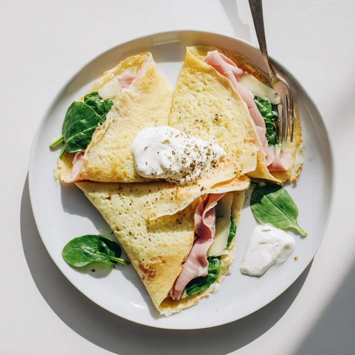French-style savory crepes topped with grated cheese and served hot for a comforting brunch meal