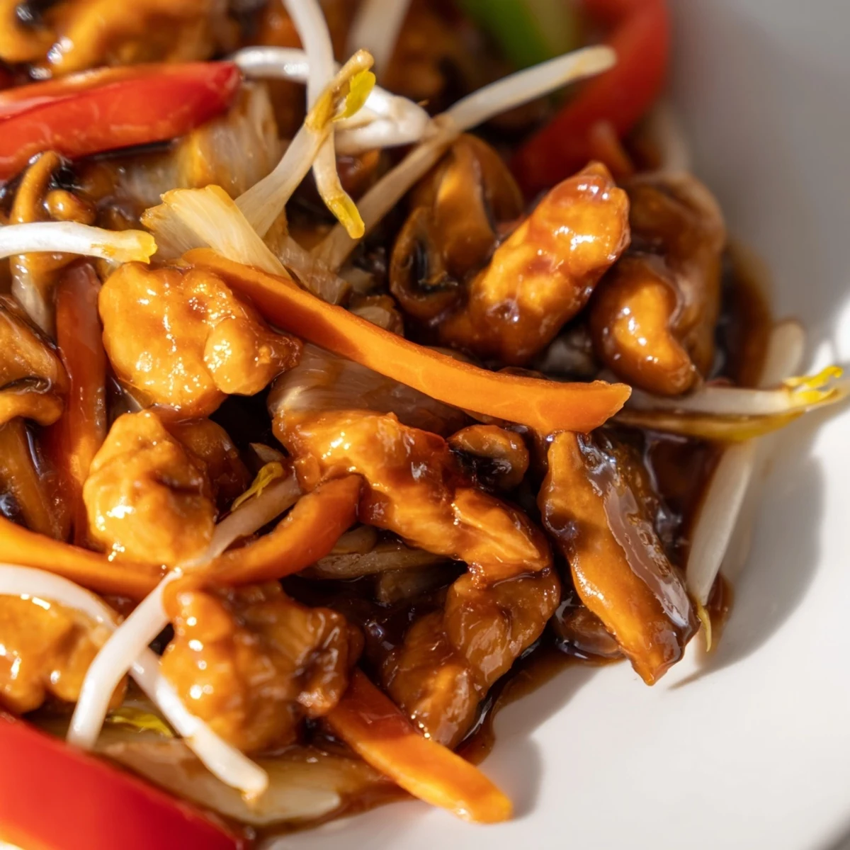 Heaping plate of Chop Suey featuring bean sprouts and cabbage over steamed white rice