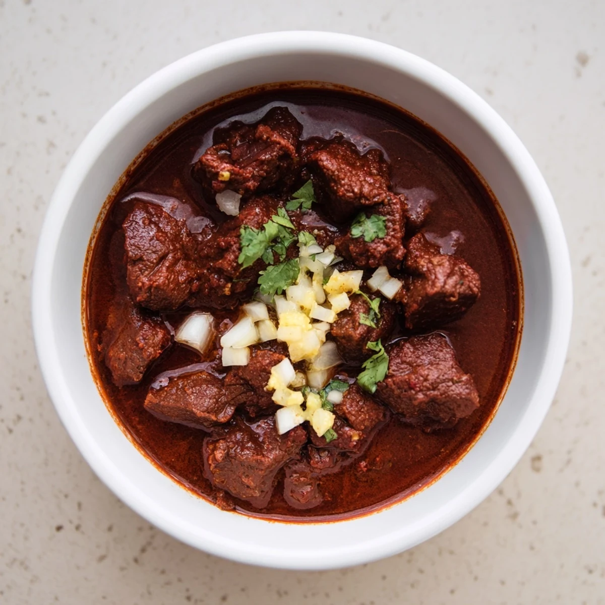 Slow cooker Crockpot Chili Colorado featuring tender beef chunks swimming in deep red chili sauce