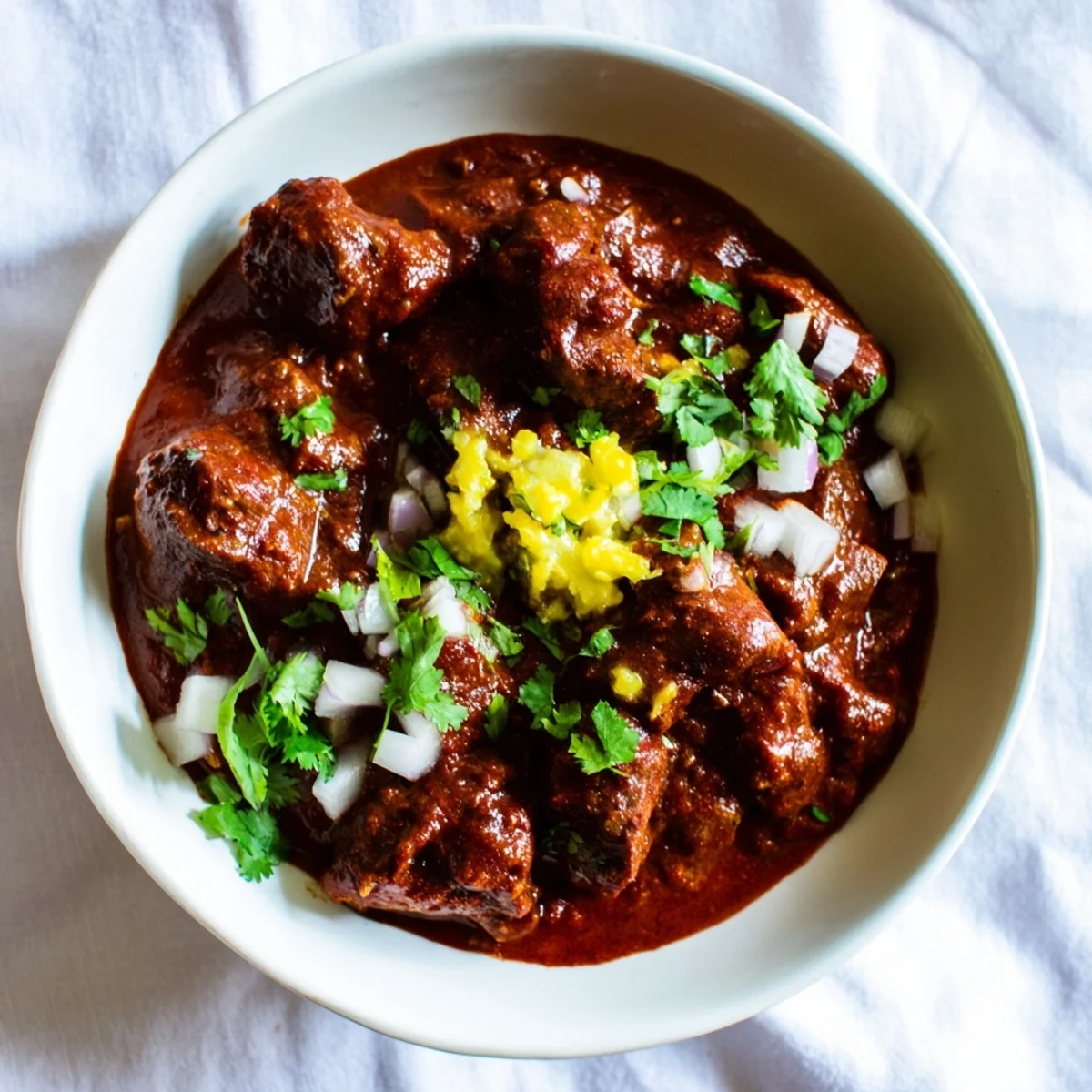 Hearty Crockpot Chili Colorado showcasing fall-apart beef in a rich, smooth red chili sauce
