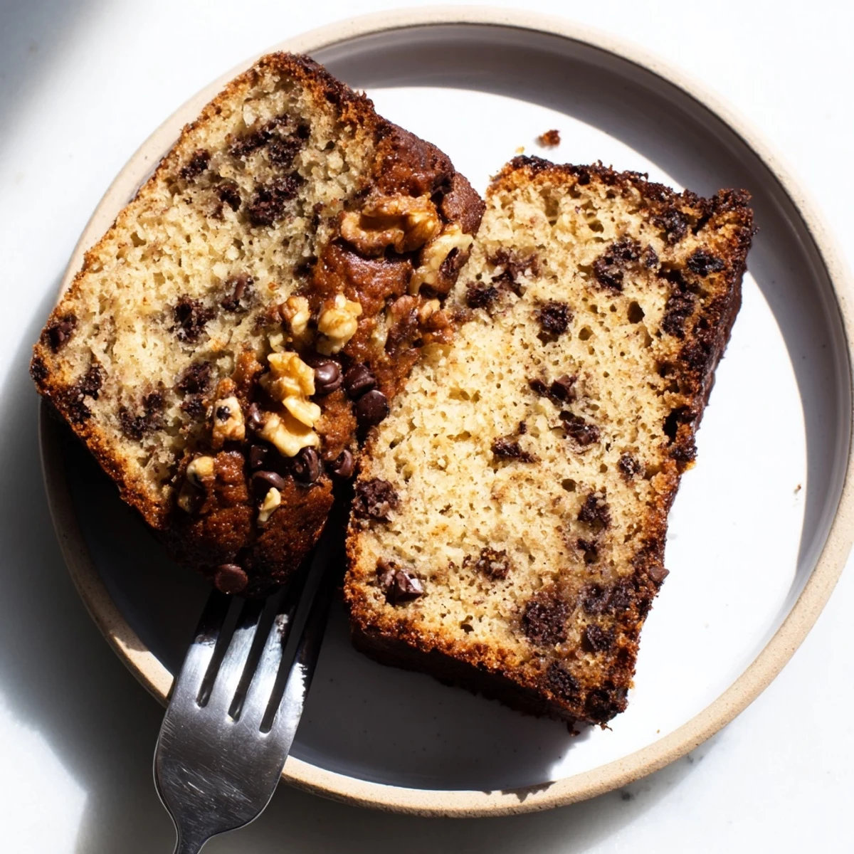 Golden chocolate chip banana bread loaf with melty chocolate chips on top