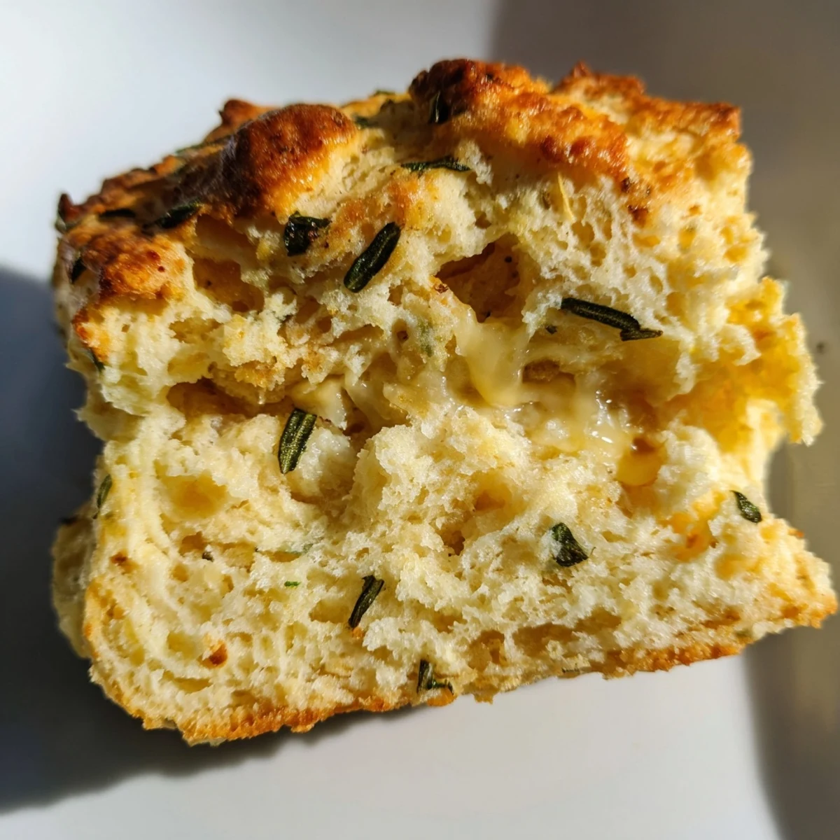 Golden brown sage and Gruyere biscuits fresh from the oven with flaky layers