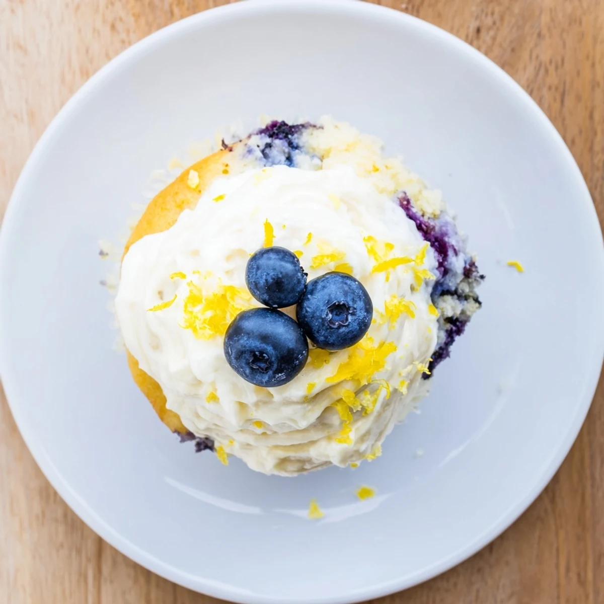 Light and fluffy lemon blueberry cupcakes bursting with juicy berries under a zesty lemon cream cheese frosting