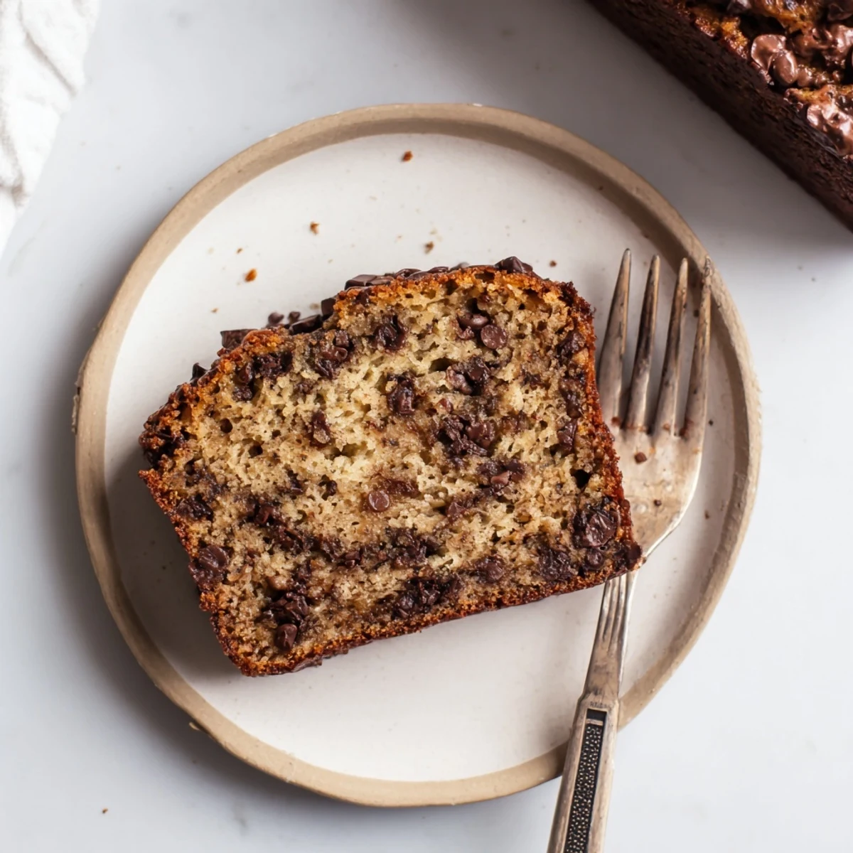Warm homemade chocolate chip banana bread fresh from the oven with steam rising