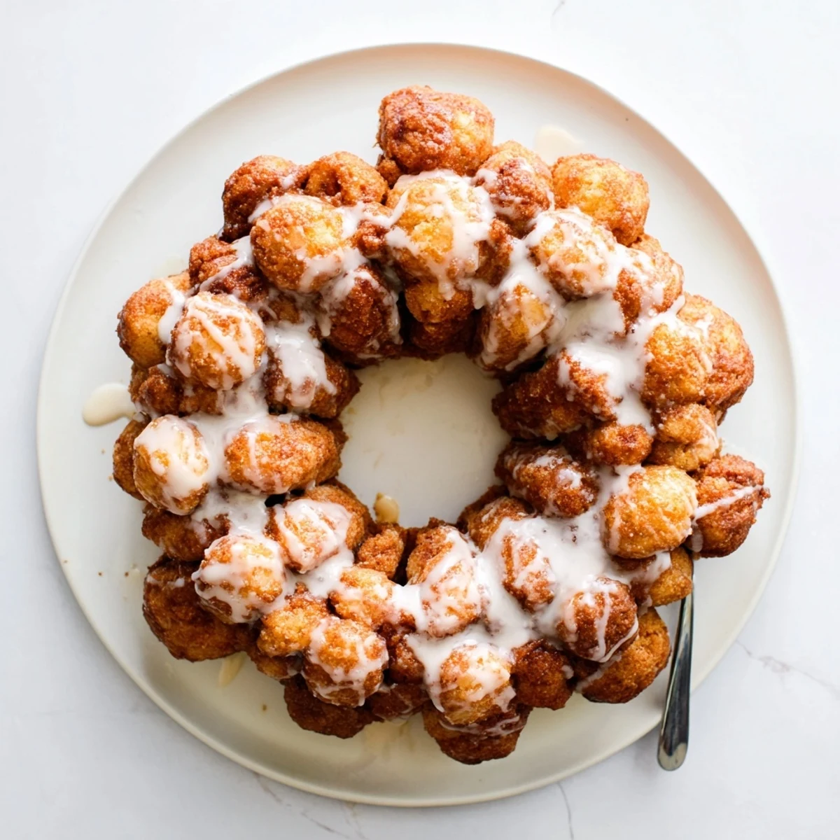 Bundt pan of high protein no sugar monkey bread showing fluffy cinnamon coated pieces ready to serve
