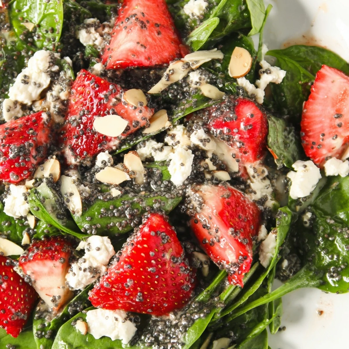 Bright Strawberry Spinach Salad with sliced berries red onion and creamy balsamic dressing