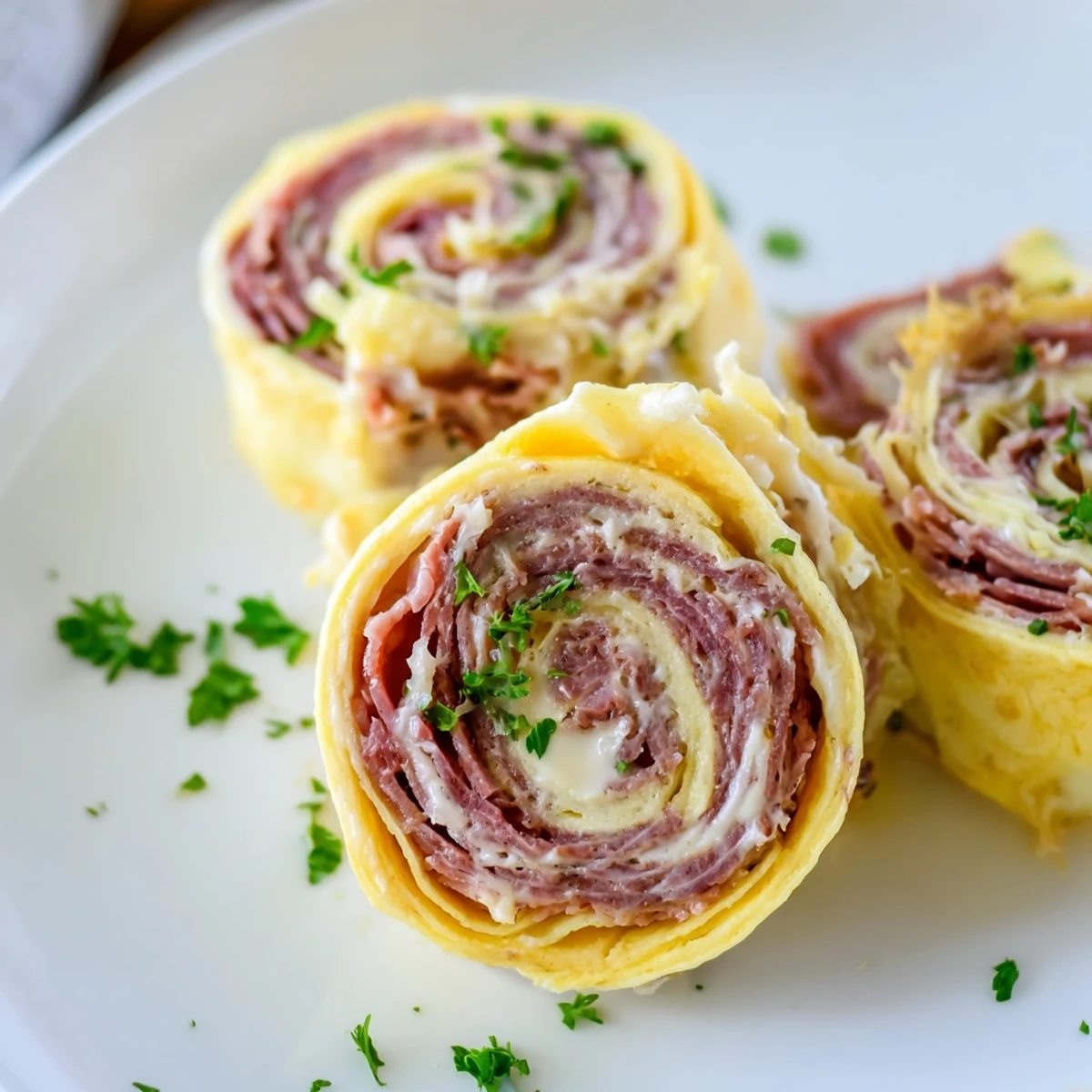 Savory low carb Reuben egg roll ups with tangy sauerkraut and creamy dressing.