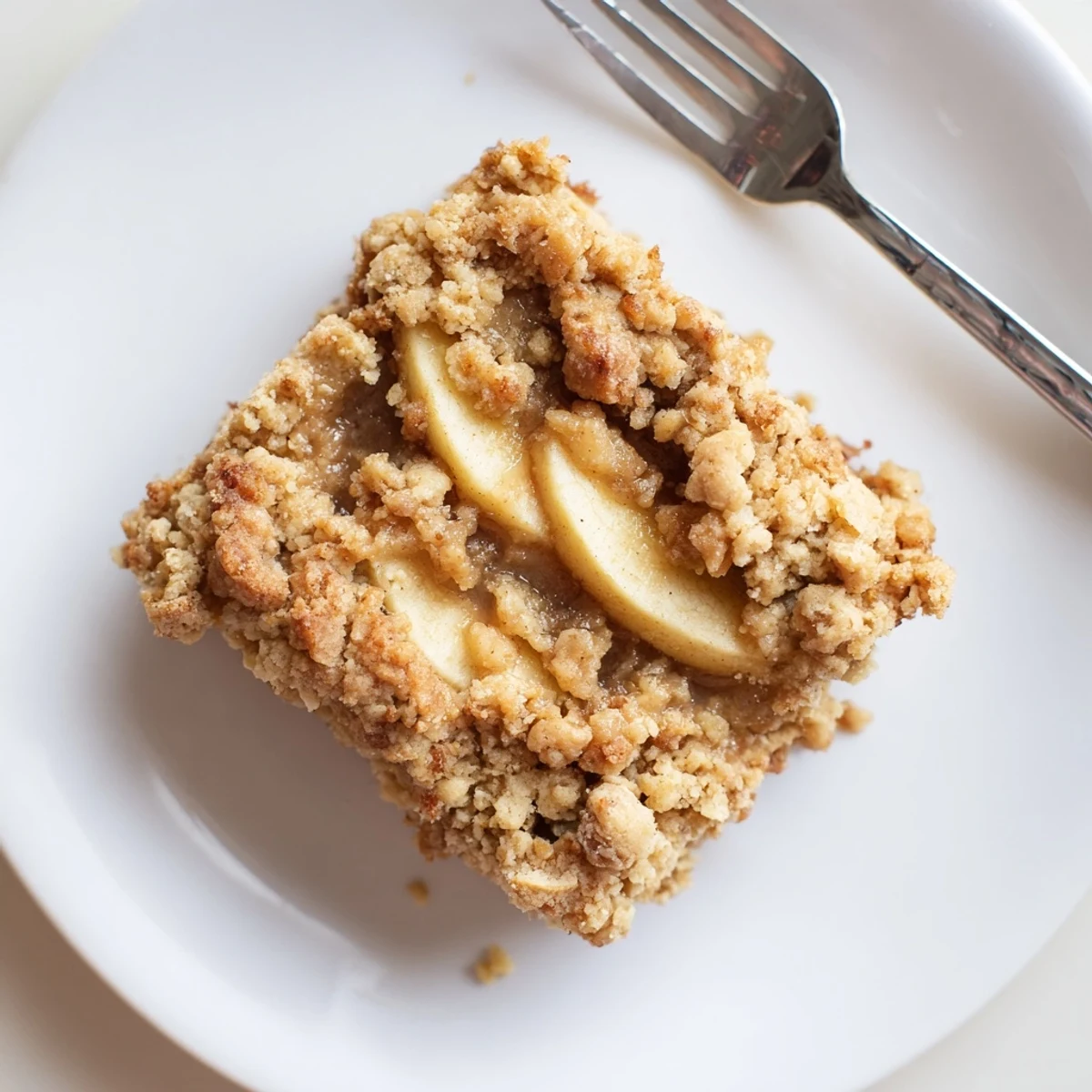 Warm caramel apple crumb bars sliced to reveal tender cinnamon-spiced apple filling