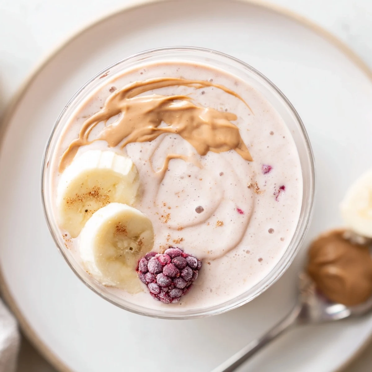 Vanilla spiked High Protein Smoothie, chilled and thick, garnished with peanut butter drizzle