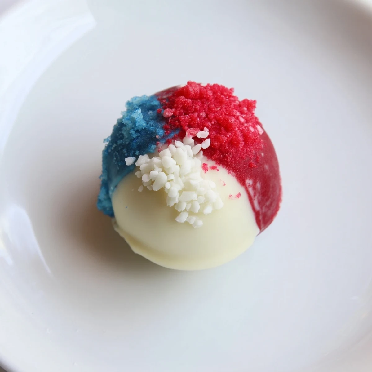 Homemade Fourth of July Truffles chilled, rolled in sparkling white sprinkles