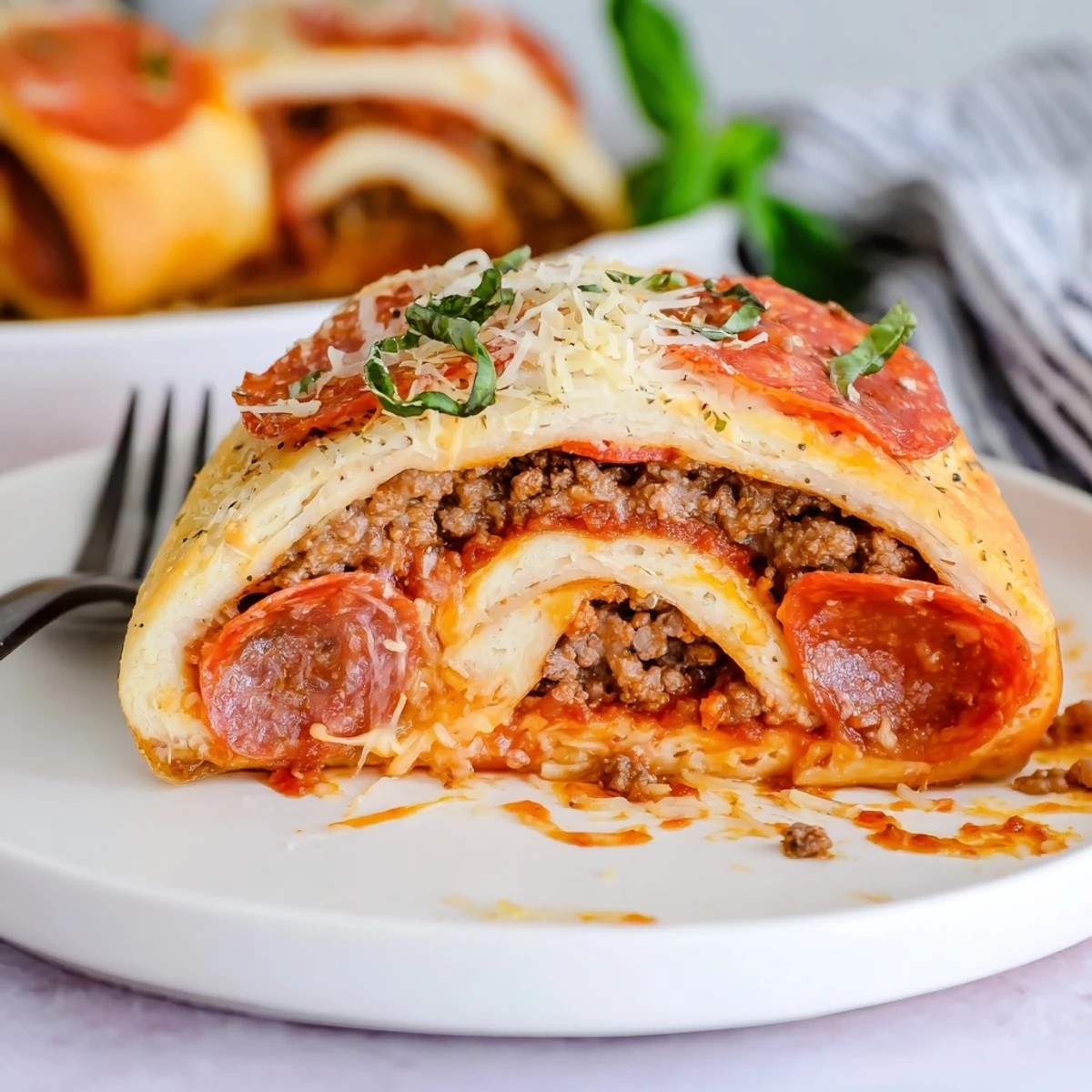 Family-style Cheesy Beef Pepperoni Pizza Roll Ups Snack Recipe with marinara for dipping