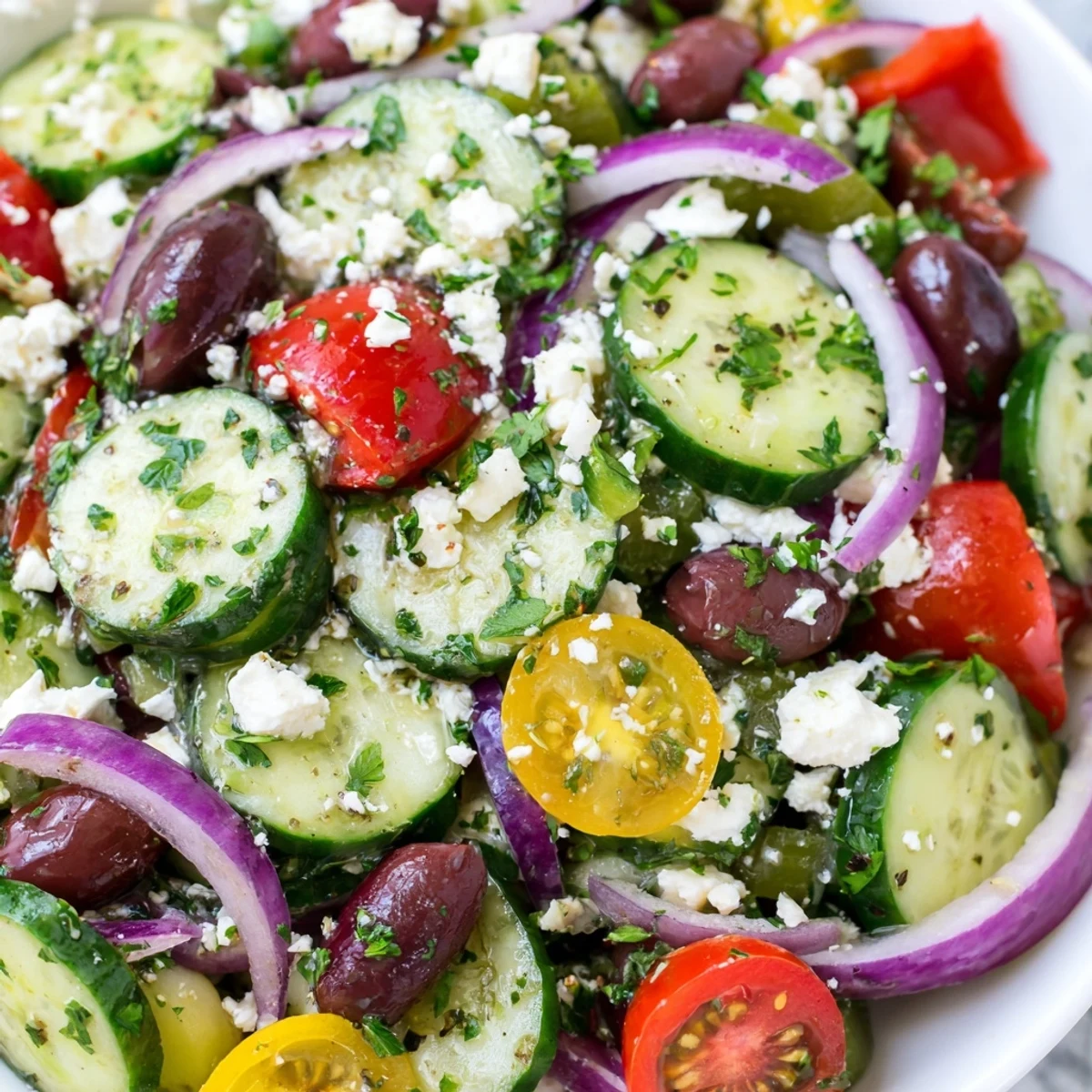 Vibrant Mediterranean cucumber salad recipe tossed in olive oil lemon dressing with Kalamata olives and fresh parsley