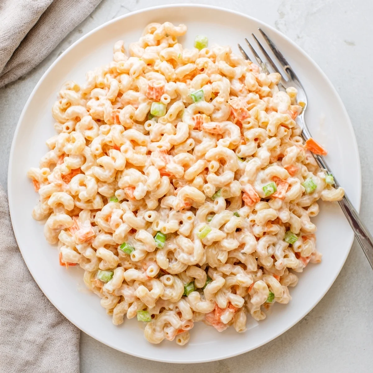 Tender elbow macaroni tossed in tangy mayonnaise dressing with colorful chopped vegetables for a classic island side dish