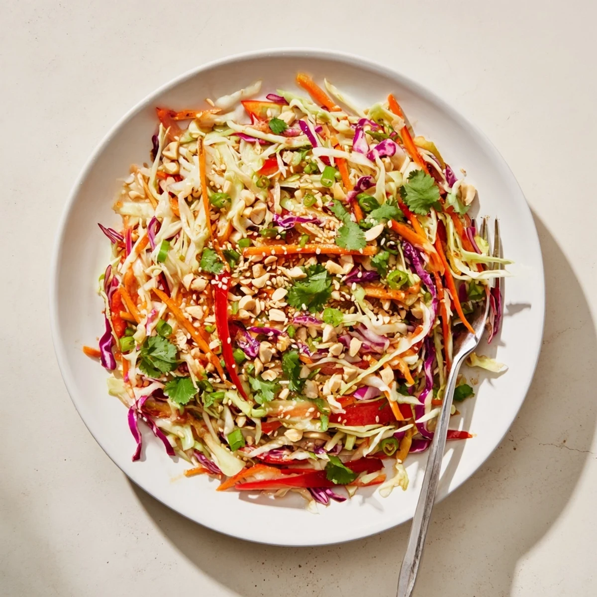 Asian Cabbage Salad piled in bowl, crisp cabbage and tangy sesame dressing