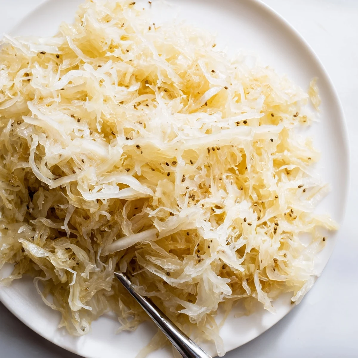 Traditional German sauerkraut served as condiment alongside hearty sausages and roasted potatoes