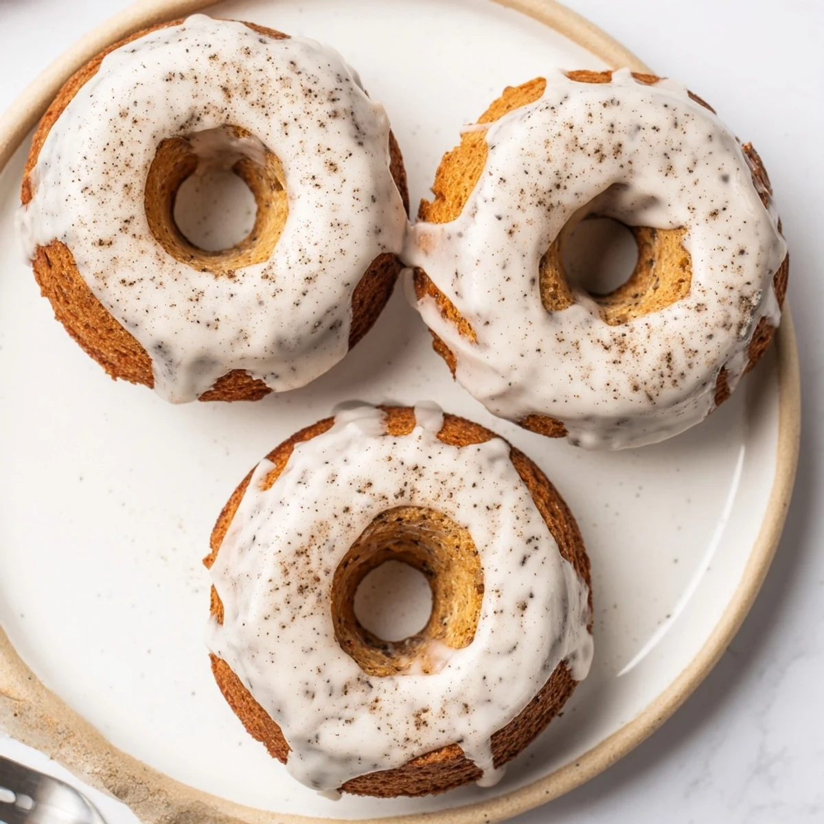 Soft moist banana bread donuts topped with powdered sugar and cinnamon spice, perfect breakfast treat