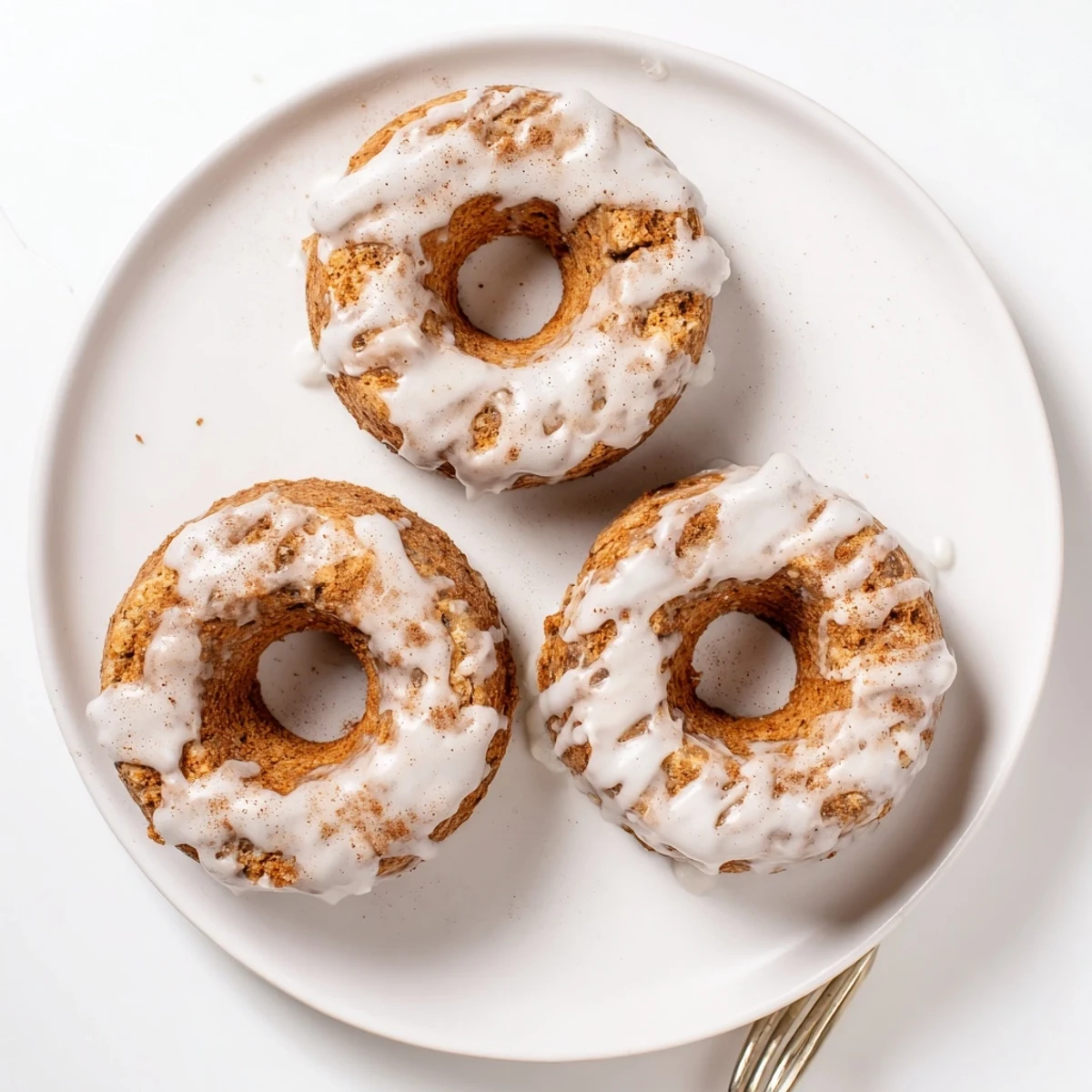Freshly baked banana bread donuts with ripe banana flavor, lightly glazed and ready for serving