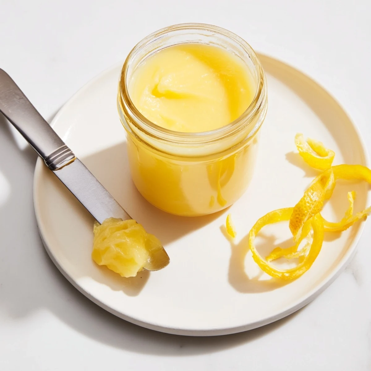 Warm Homemade Lemon Curd cooling in bowl, glossy thickness, lemon scent