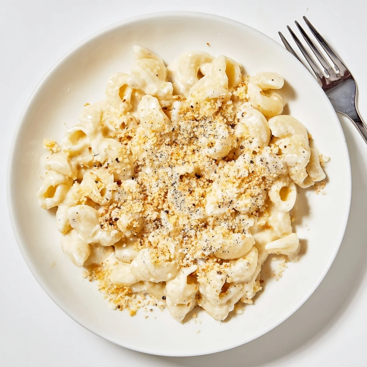 Creamy homemade mac and cheese served in a white bowl with rich melted cheese topping