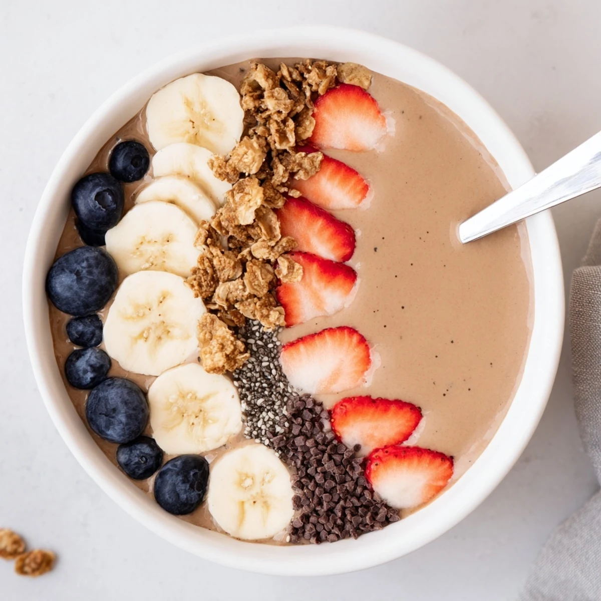 Chilled Coffee Protein Smoothie Bowl Recipe served with sliced banana and berries