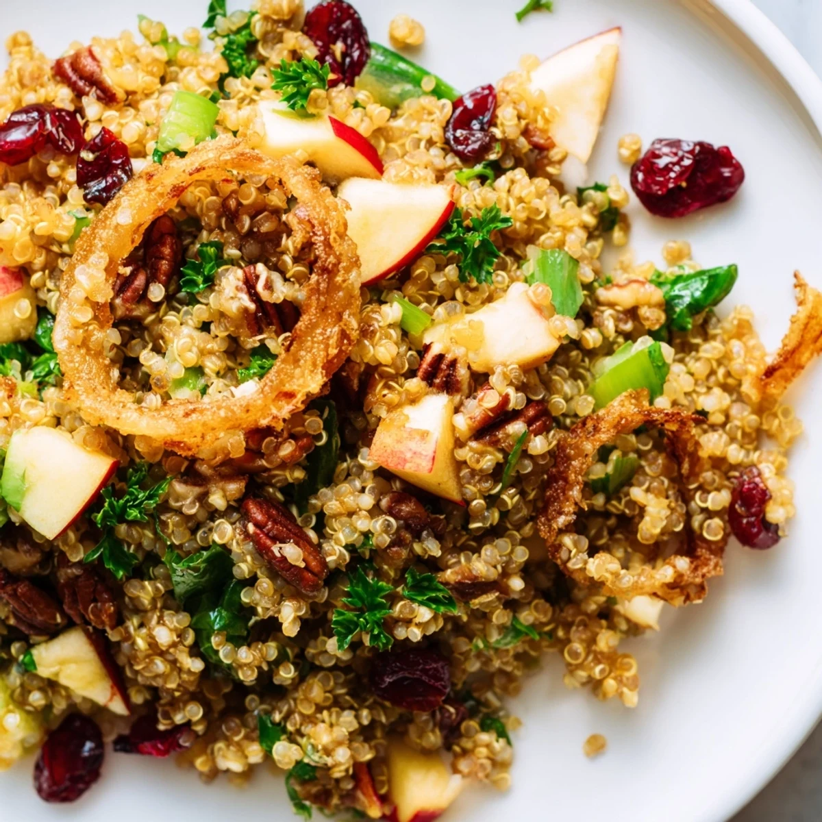 Vibrant honey mustard quinoa apple salad with cranberries, pecans, and crunchy fried shallots served fresh