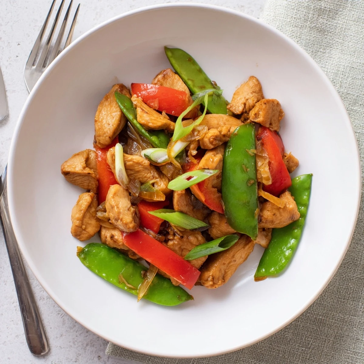 Stir Fried Chinese Garlic Chicken glistening with glossy garlic sauce over jasmine rice