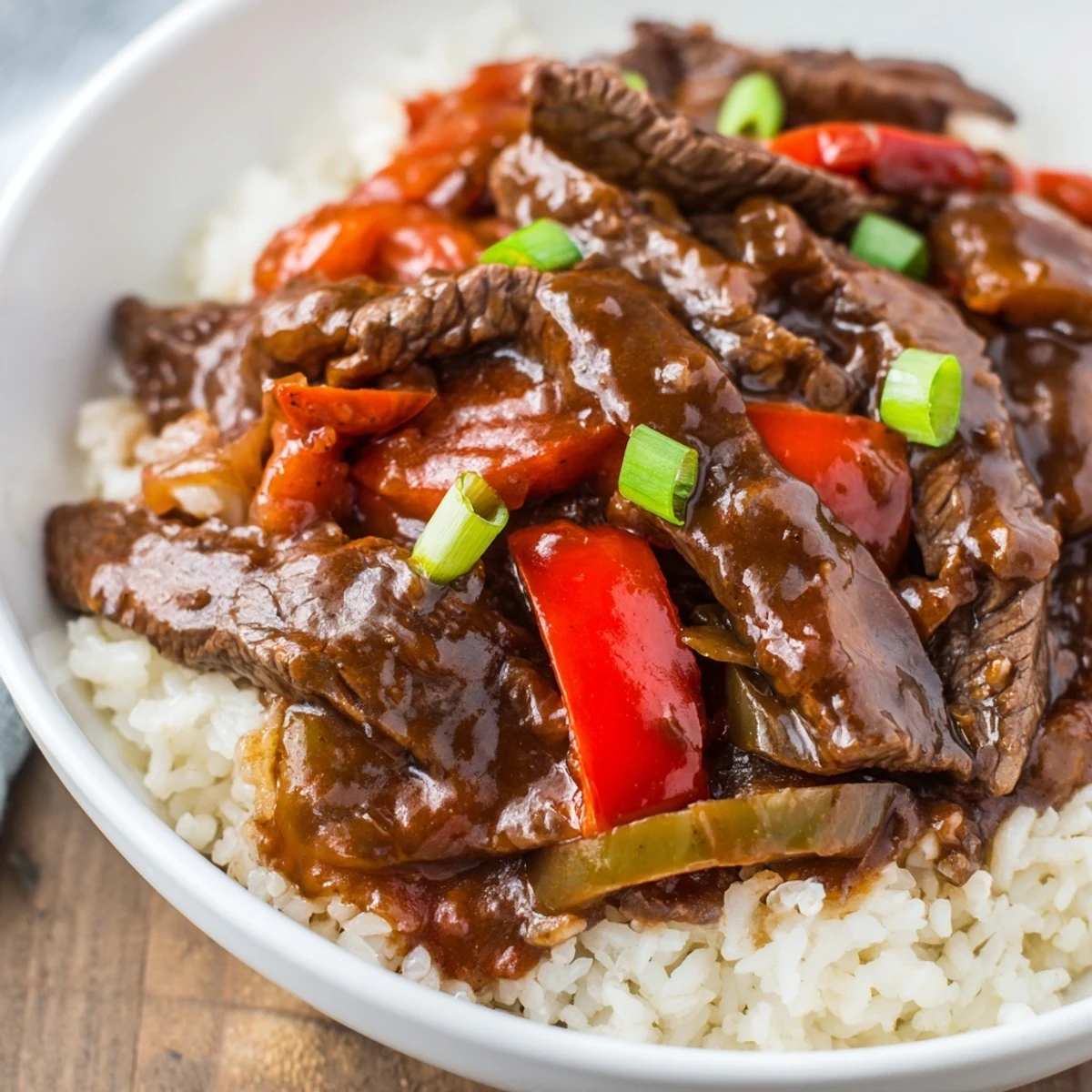 Juicy strips of slow cooker pepper steak simmered in rich savory sweet brown sauce
